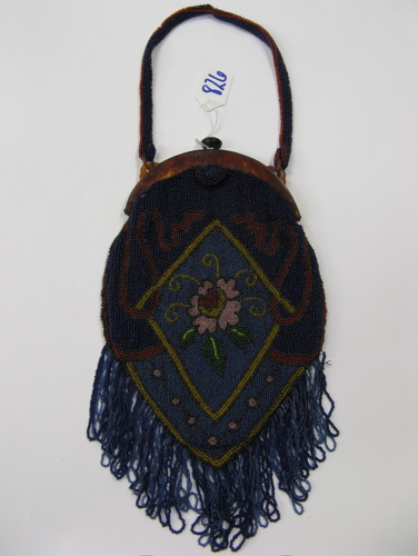 Appraisal: AMERICAN LADY'S BEADED BAG supported on a Pyrolin curved frame