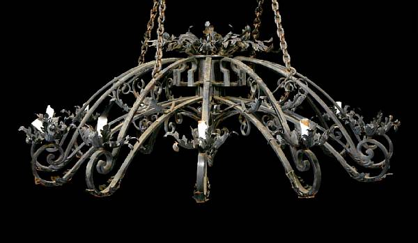 Appraisal: A Spanish Baroque style wrought iron and tole twelve light