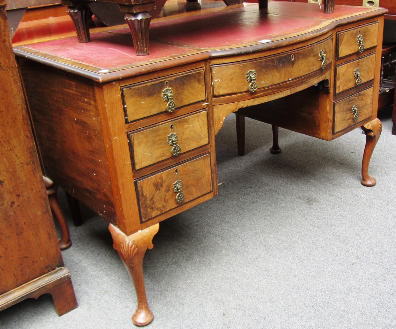 Appraisal: An early th century walnut bowfront seven drawer writing desk