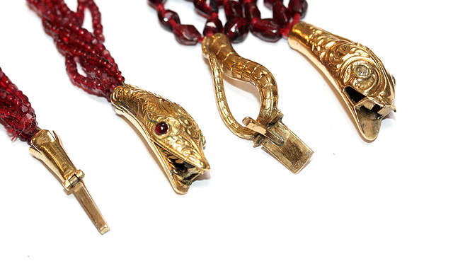 Appraisal: A THREE STRAND FACETED GARNET NECKLACE with snake and tail