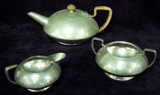 Appraisal: A Tudric Pewter three-piece tea service of circular form and