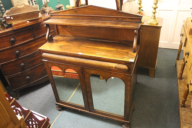 Appraisal: A VICTORIAN ROSEWOOD CHIFFONIER with mirrored doors enclosing two fitted