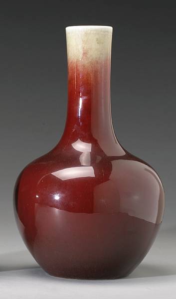 Appraisal: A copper red glazed porcelain stick neck vase th Century