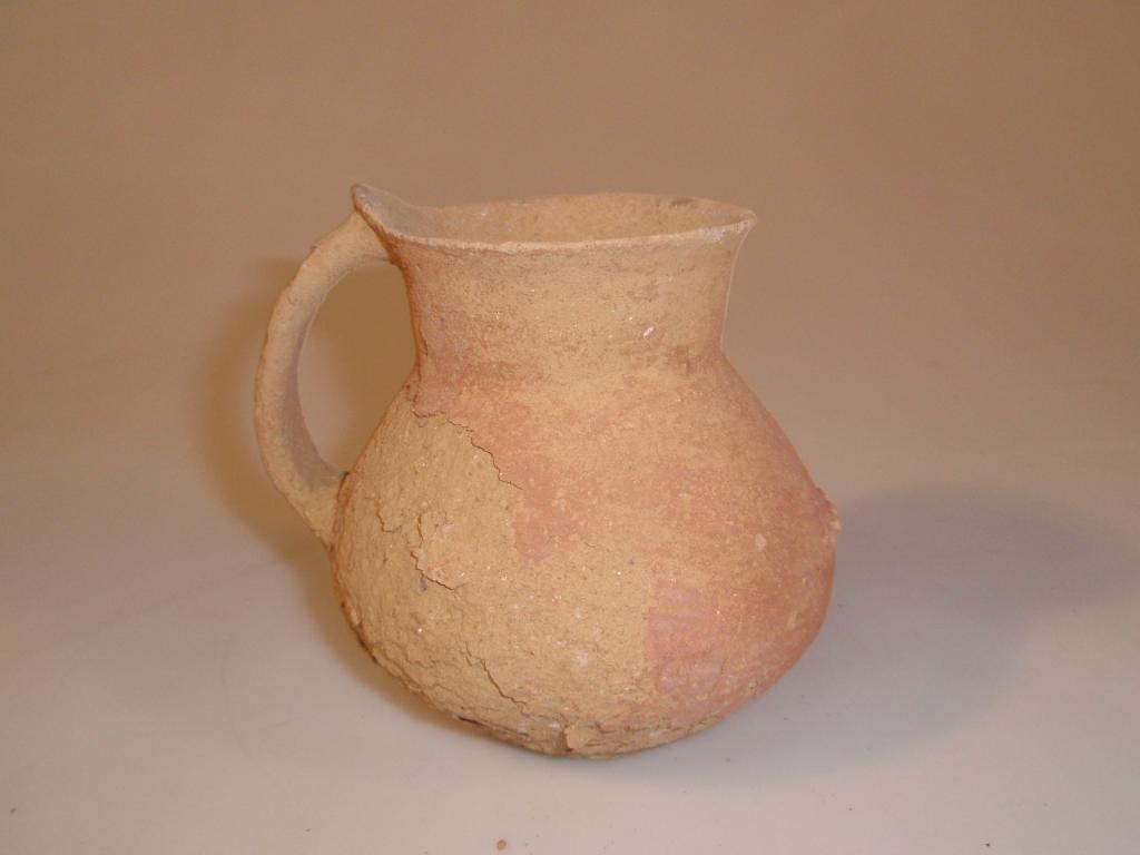 Appraisal: A small thin-walled wheel-made pottery jug or handled jar the