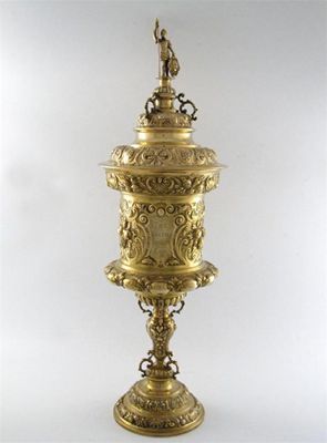 Appraisal: A silver-gilt presentation standing cup and cover embossed foliate scroll