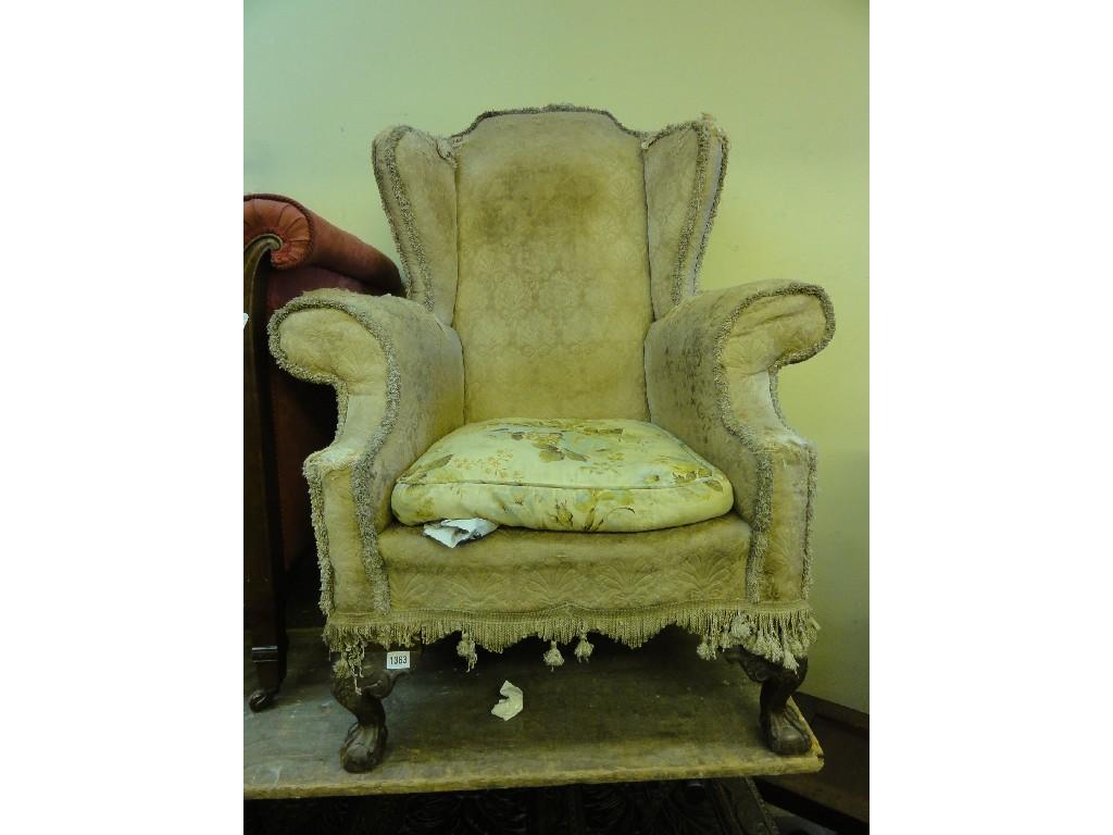 Appraisal: A Georgian style wing armchair with shaped outline cream ground