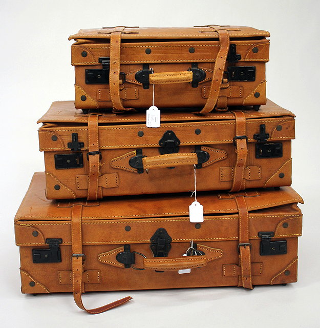 Appraisal: A GRADUATED SET OF THREE LIGHT BROWN LEATHER SUITCASES the