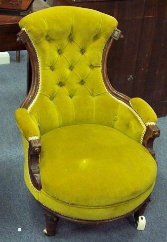 Appraisal: A Victorian easy chair with carved supports to the half