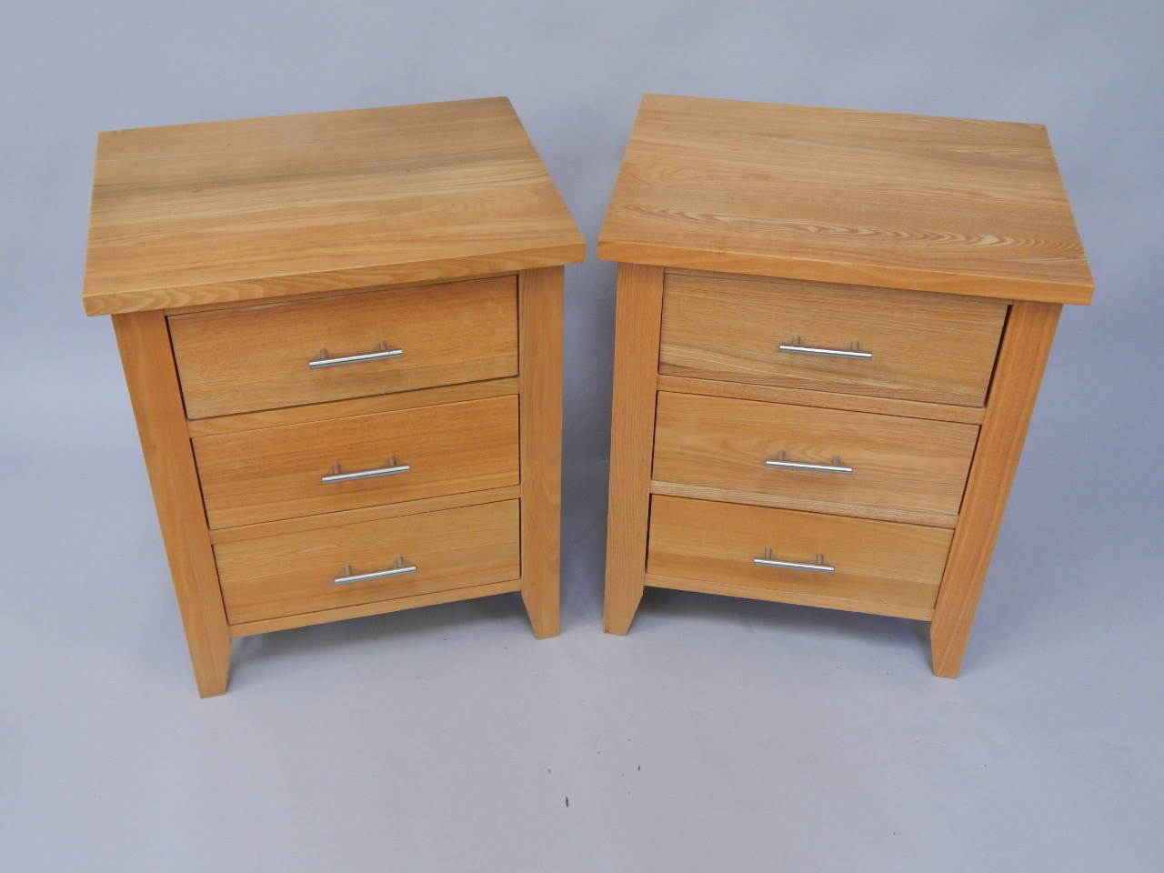 Appraisal: A pair of modern light oak three drawer cabinets each