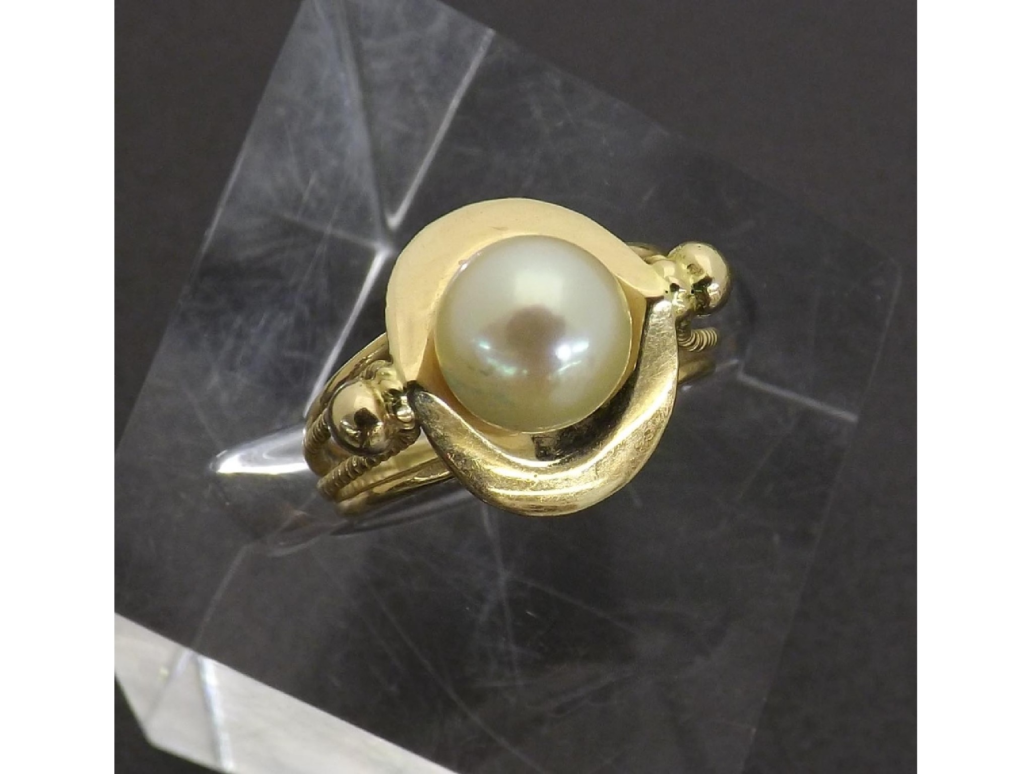 Appraisal: Yellow gold dress ring set with a single cultured pearl