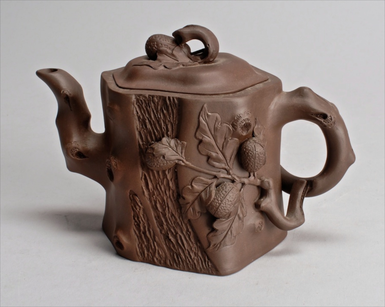 Appraisal: EARLY TH CENTURY YIXING POTTERY TEAPOT in dark brown tree