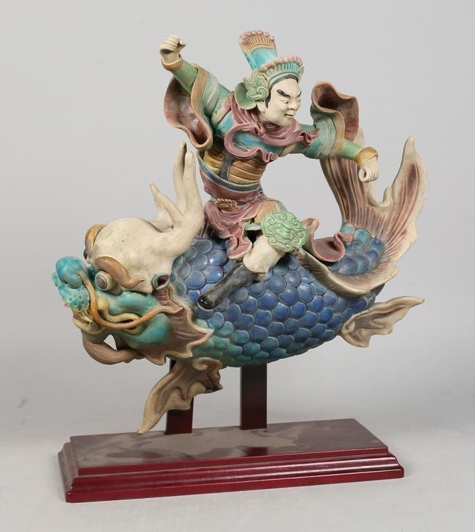 Appraisal: Chinese ceramic roof tile statue of a man riding a