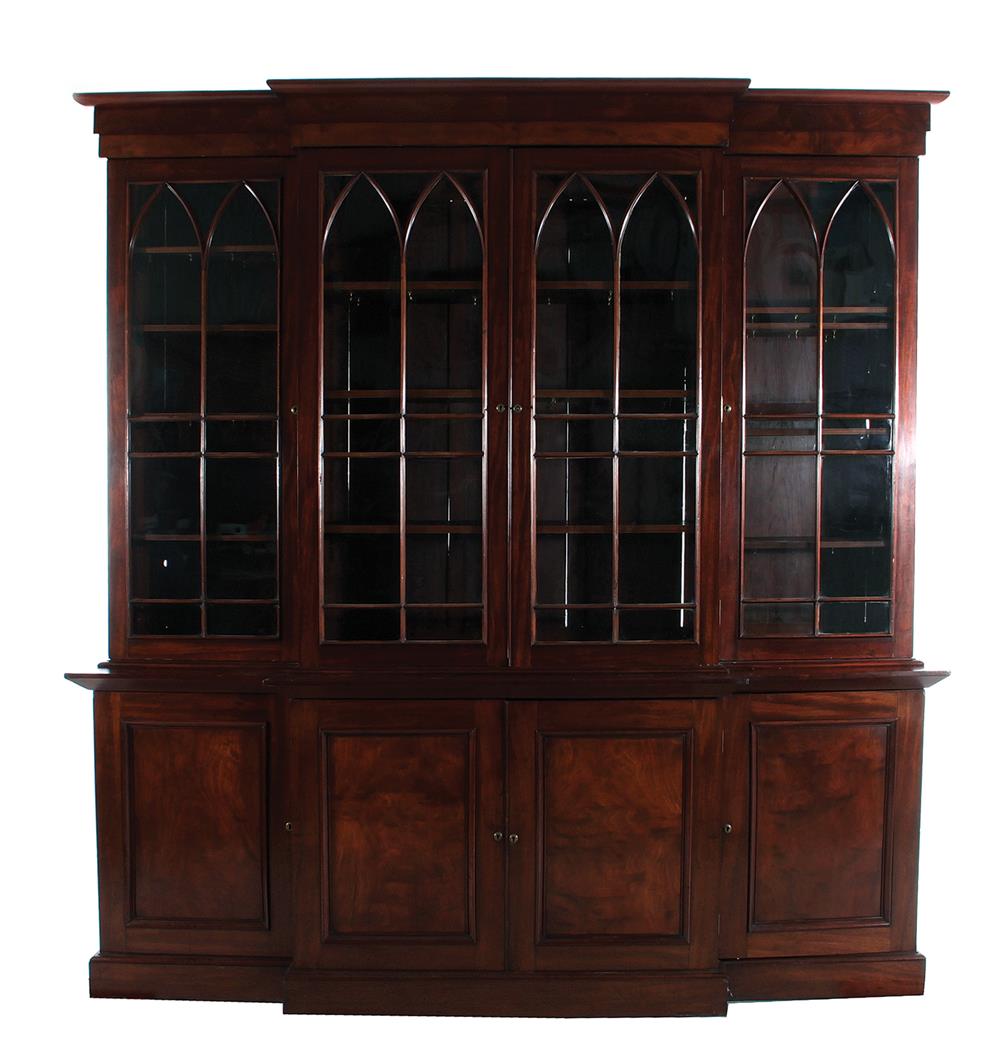 Appraisal: American mahogany breakfront bookcase th century Gothic arch divided glazed