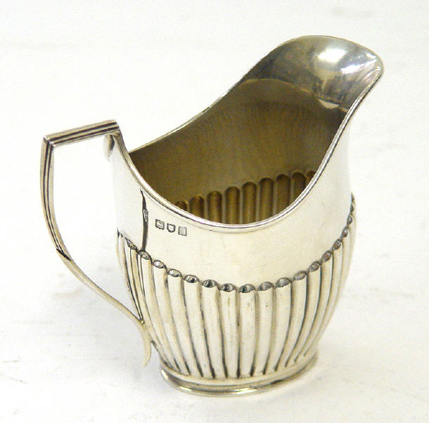 Appraisal: Reeded Edwardian silver cream jug London cm high