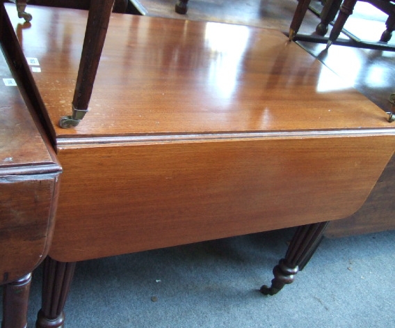 Appraisal: A George IV mahogany drop-flap table with single frieze drawer