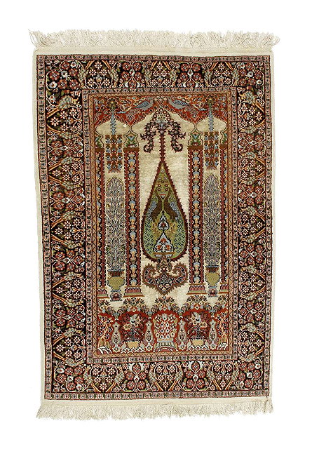 Appraisal: A Persian ivory ground prayer rugwith central palm leaf design