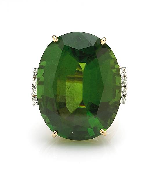 Appraisal: A peridot and diamond ring centering an oval-shaped peridot weighing