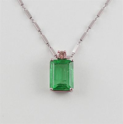 Appraisal: An emerald and diamond pendant The emerald cut emerald is