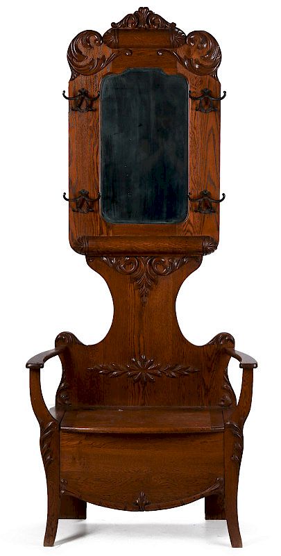 Appraisal: A CIRCA AMERICAN OAK HALL SEAT WITH MIRROR The ornate