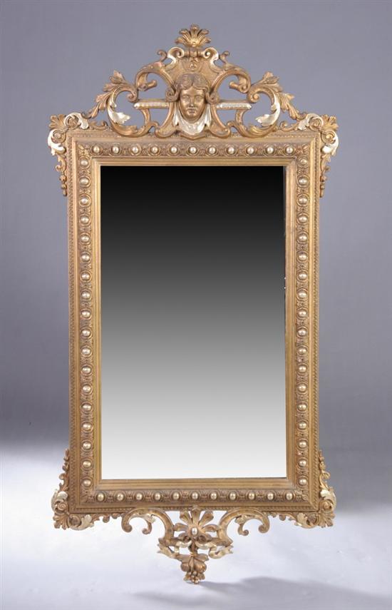 Appraisal: RENAISSANCE REVIVAL GILT AND COMPOSITION WALL MIRROR th century Mask