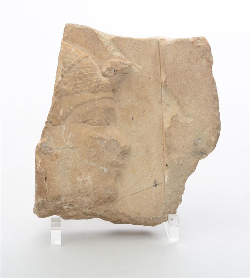 Appraisal: EGYPTIAN CARVED LIMESTONE FRAGMENT Depicting a profile of a man