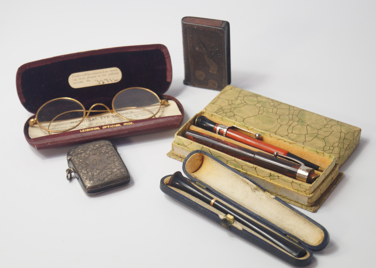 Appraisal: An ebony cigarette holder with a gold band cased George