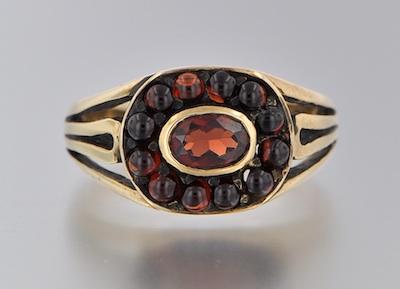 Appraisal: An English Gold and Garnet Ring k yellow gold ring