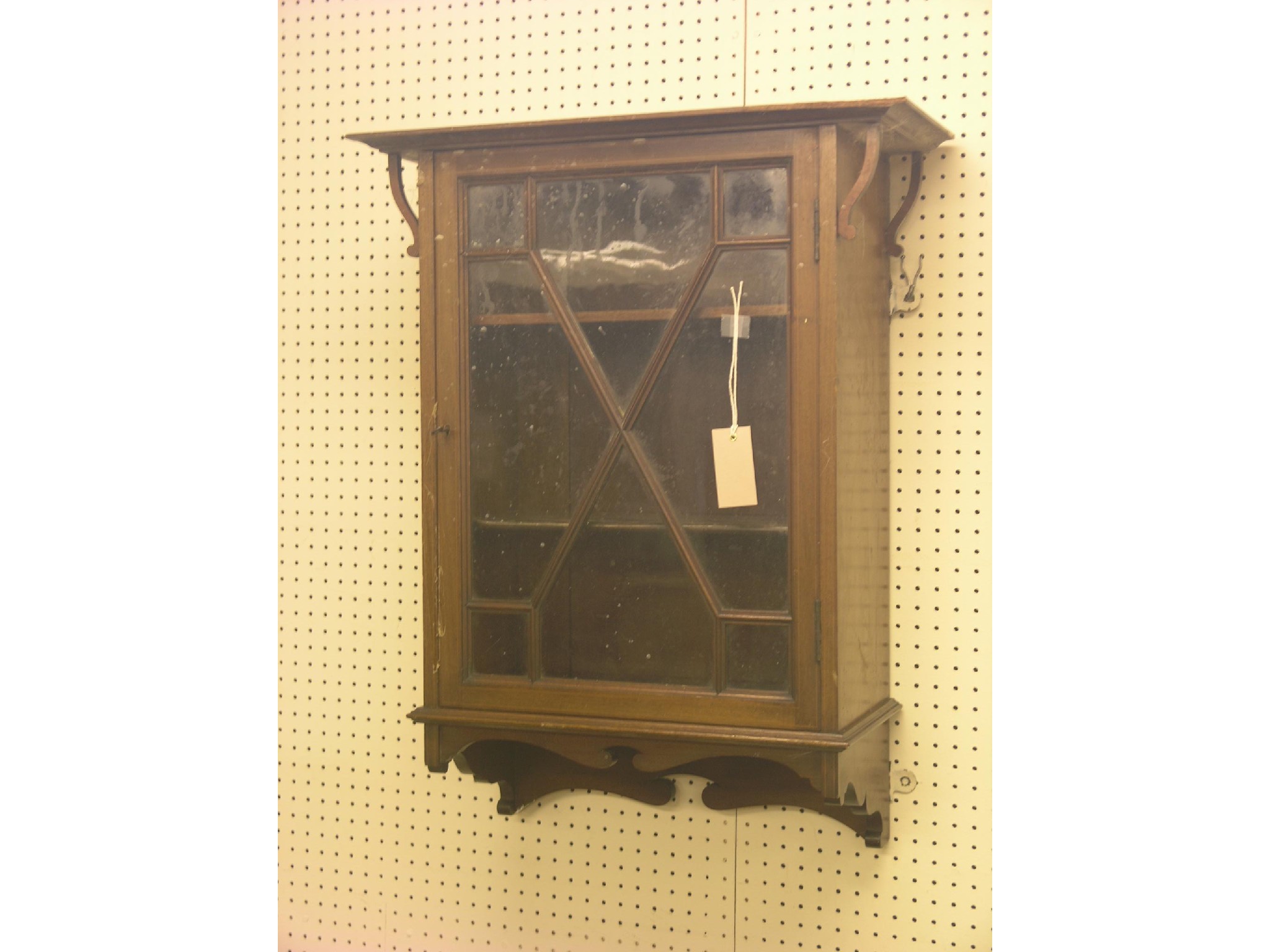 Appraisal: A wall-hanging inlaid mahogany display cabinet enclosed by astragal-glazed door