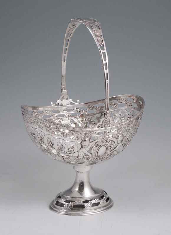 Appraisal: GERMAN SILVER CHERUBIC RETICULATED BASKET Baske on pedestal base with