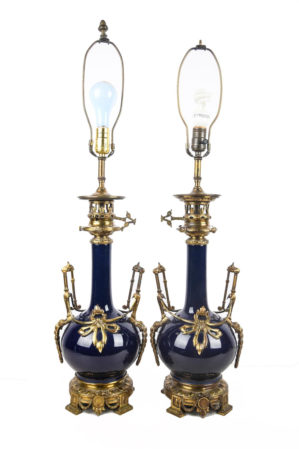 Appraisal: PAIR OF COBALT PORCELAIN METAL MOUNTED LAMPSCondition with loss to