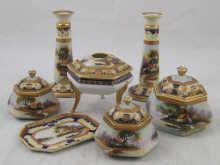 Appraisal: A Japanese porcelain dressing table set comprising candlesticks three lidded