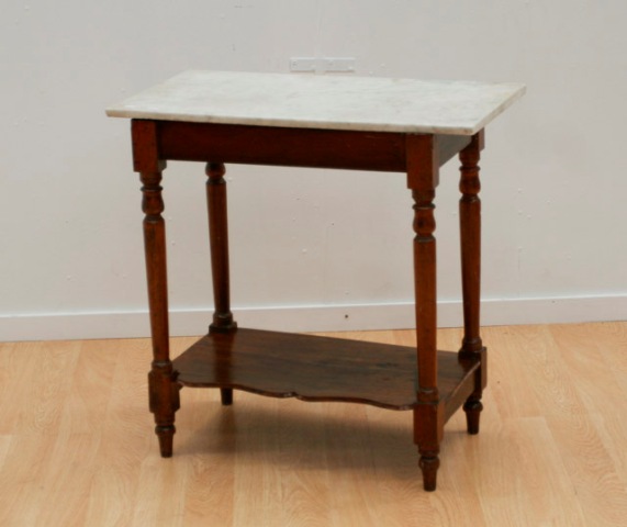 Appraisal: A marble topped cedar occasional table