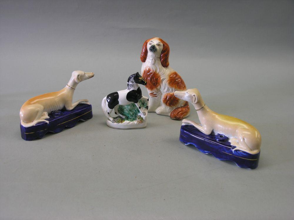 Appraisal: A pair of Victorian Staffordshire greyhound quill stands each dog