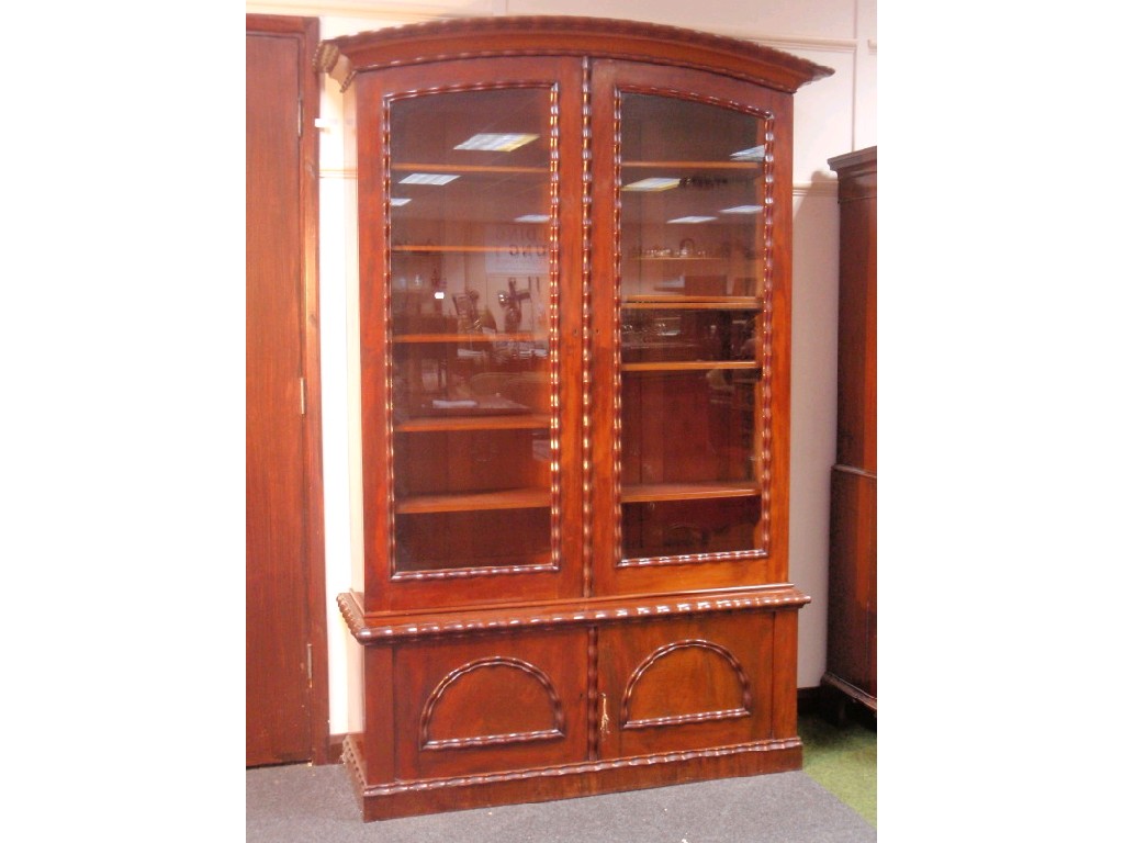 Appraisal: A Victorian figured mahogany stepped bookcase the upper glazed cabinet