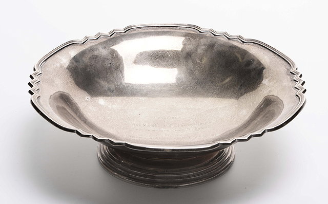 Appraisal: A SILVER BOWL with a shaped edge and stepped foot