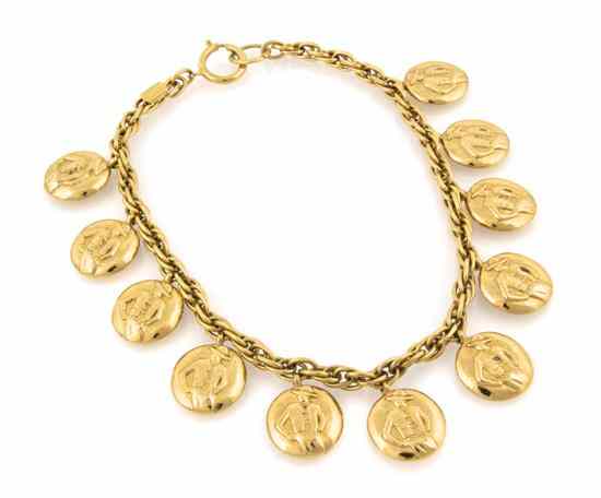 Appraisal: A Chanel Goldtone Charm Necklace disk charms depicting the torso