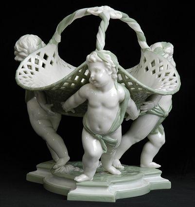 Appraisal: MINTON CELADON AND IVORY-GLAZED MAJOLICA CENTERPIECE The pierced trefoil basket