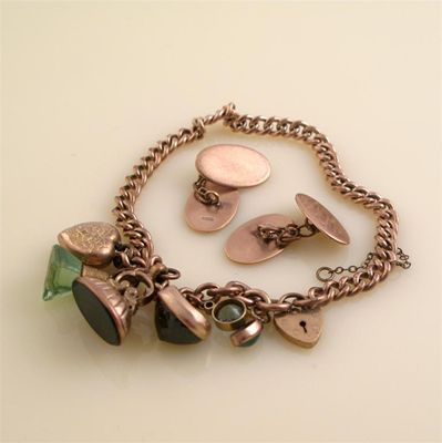 Appraisal: A gold curb link bracelet with assorted charms And a