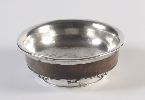 Appraisal: A Tibetan silver mounted wooden bowl decorated with turquoise and