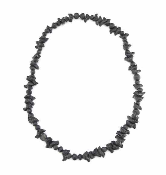 Appraisal: A Jet Fetish Necklace with carved birds and round beads