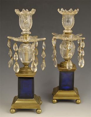 Appraisal: A pair of brass and cut glass candlesticks with blue