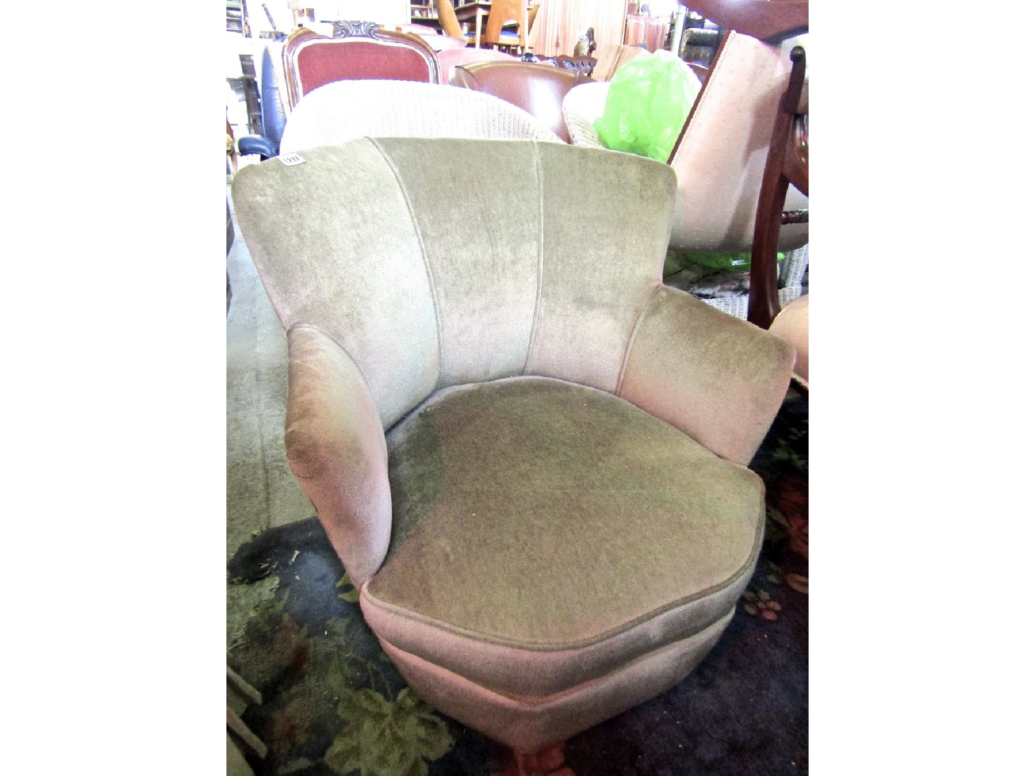 Appraisal: A low Art Deco style upholstered chair with shaped outline