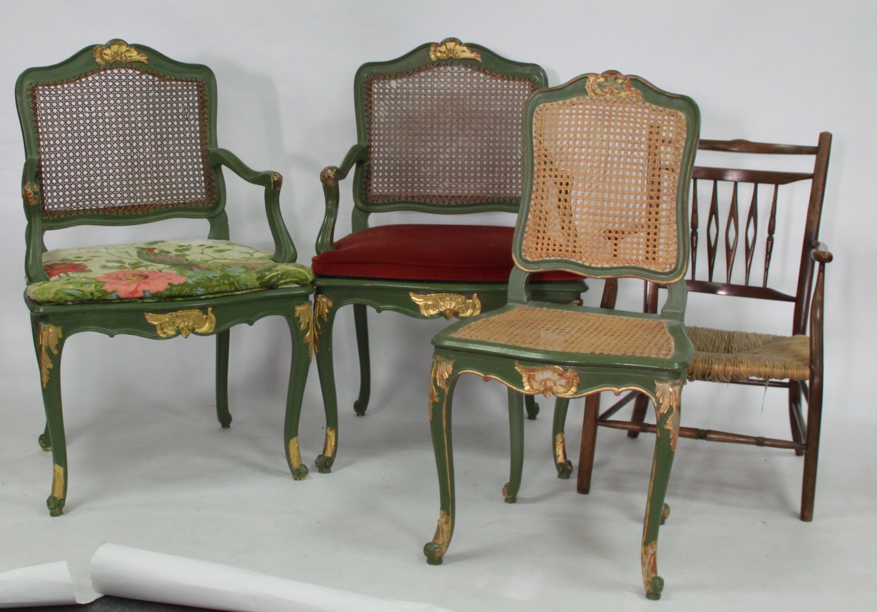 Appraisal: A pair of green painted open armchairs with cane backs