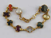 Appraisal: A yellow metal tests carat gold bracelet set with semi-precious