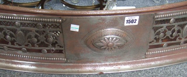 Appraisal: A Victorian brushed steel bowfronted fire fender with pierced swag