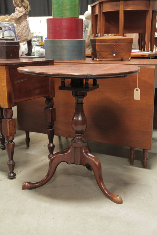 Appraisal: TILT TOP TABLE Walnut having a round top birdcage support