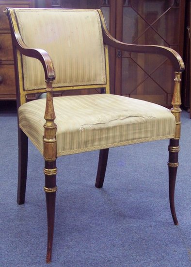 Appraisal: An upholstered armchair with parcel gilt decoration on splay feet