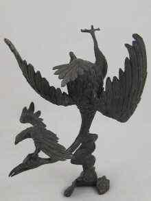 Appraisal: A Chinese bronze group of a phoenix diving over clouds