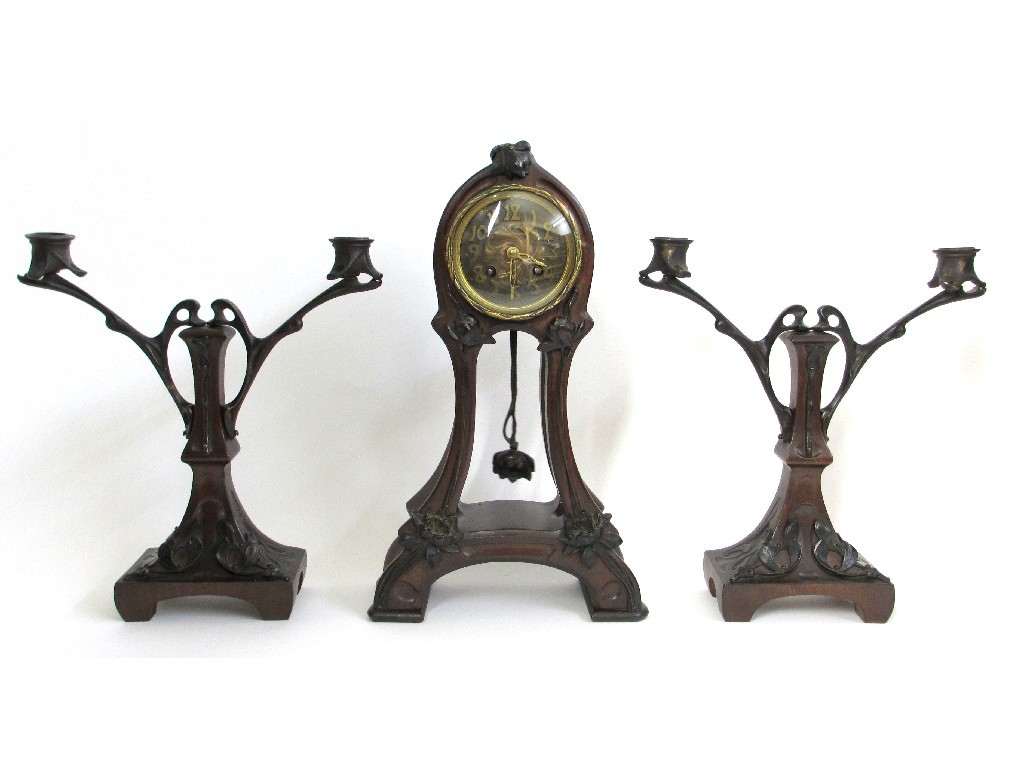 Appraisal: An Art Nouveau mahogany clock garniture of foliate form the