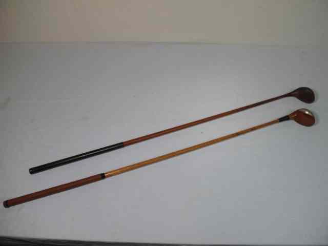 Appraisal: Two wooden shaft left handed golf clubs One is marked